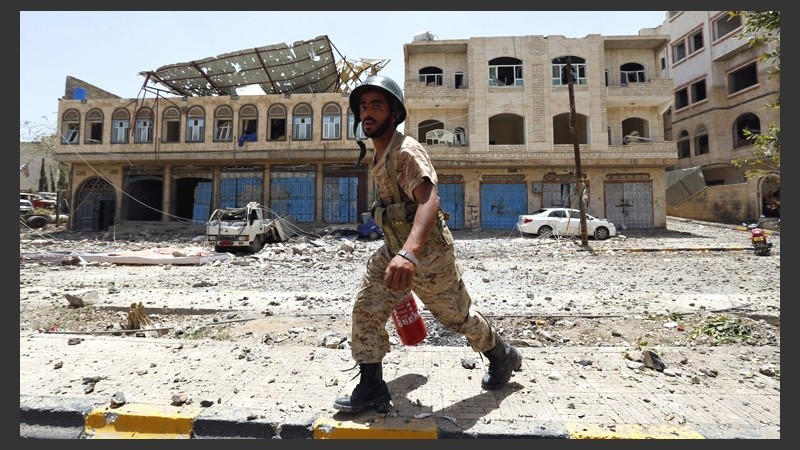 Un miliciano hutí intenta extinguir el fuego tras un supuesto bombardeo de la coalición árabe en Saná, Yemen.