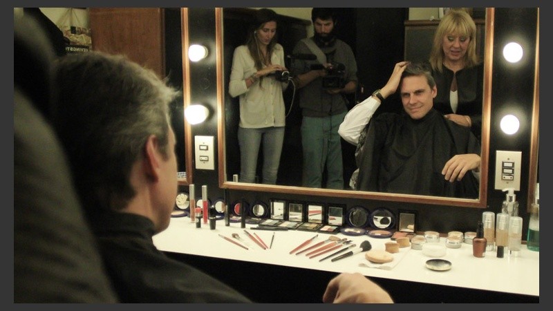 El candidato Grandinetti  se mira al espejo antes de ser maquillado.