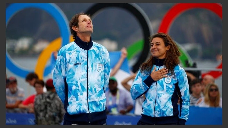 Cecilia al momento de recibir el oro olímpico, junto a su compañero Santiago Lange.