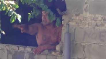 El supuesto violador en la ventana desde la que discutía con los vecinos.