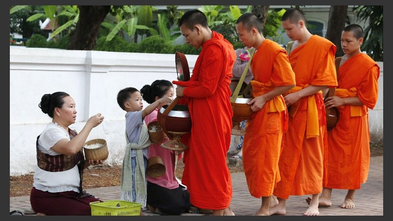 Los monjes tienen como ritual buscar las ofrendas por la mañana. Gran cantidad de turistas y residentes de la zona participan diariamente.