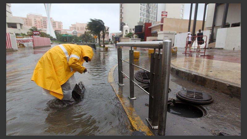 Un empleado municipal trabaja en una calle inundada en Acapulco.