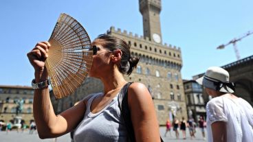 Una mujer usa un abanico para combatir el calor en una calle de Florencia, Italia. (EFE)