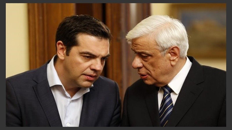 Tsipras conversa con el presidente griego, Prokopis Pavlópulos.