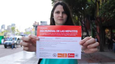 Una chica muestra un folleto en el Día Mundial contra las Hepatitis. (Rosario3.com)
