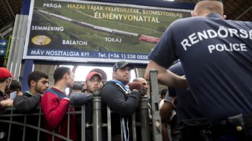 Inmigrantes esperan en una estación de trenes de Hungría.