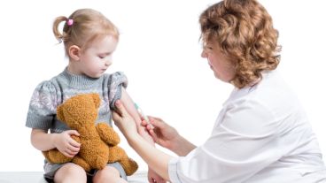 doctor vaccinating kid isolated on a white