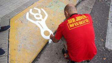 Uno de los militantes realiza una pintada en la puerta del Concejo. (Alan Monzón/Rosario3.com)