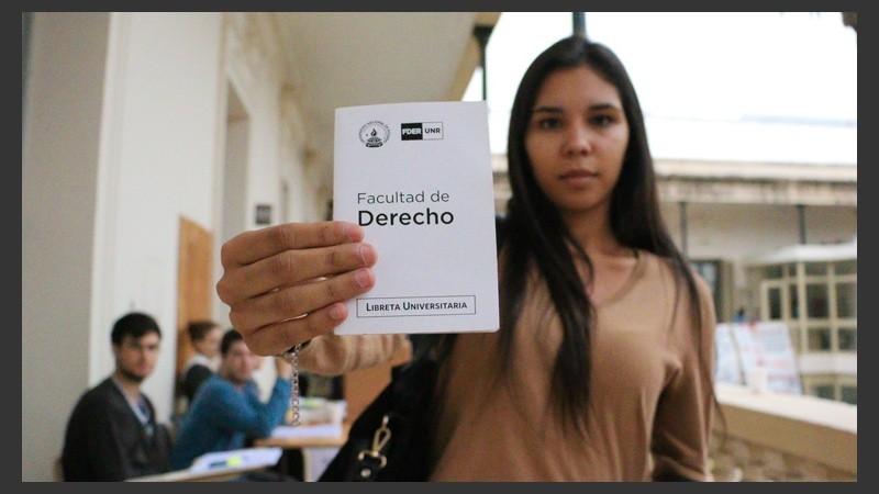 Una estudiante muestra su libreta de la Facultad de Derecho. (Alan Monzón/Rosario3.com)