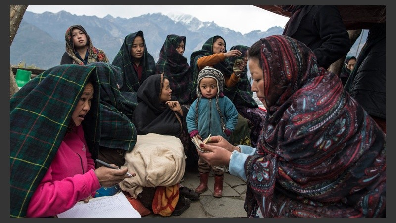 Un grupo de mujeres reúnen dinero durante su reunión mensual en la localidad de Barpak, distrito de Gorkha. (EFE)