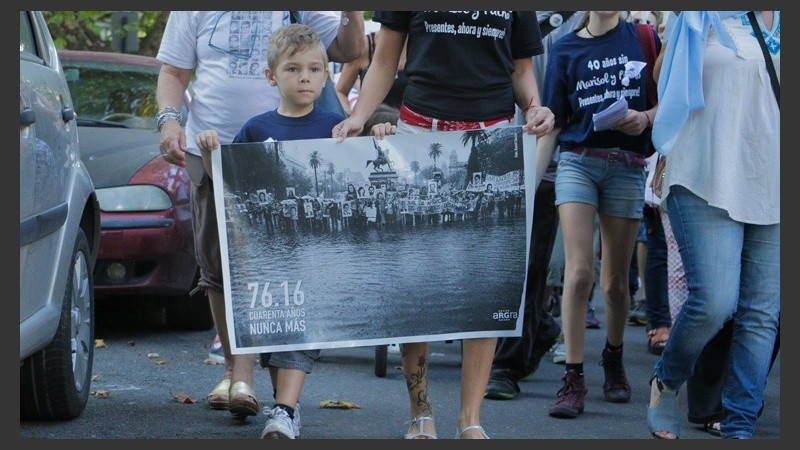 Un niño sostiene un cartel en la marcha del 24 de marzo en Rosario. Personas de todas las edades se hicieron presentes. 