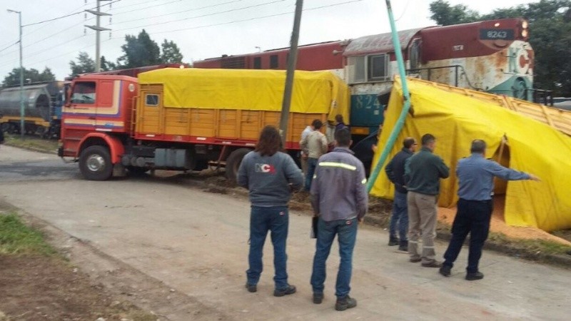 El camión destrozado y la carga sobre las vías.