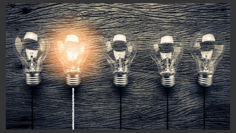 creativity ideas concept with light bulb on wooden texture background