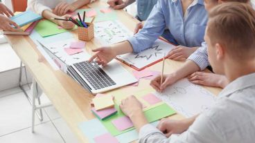 Young team working with marketing plan in office