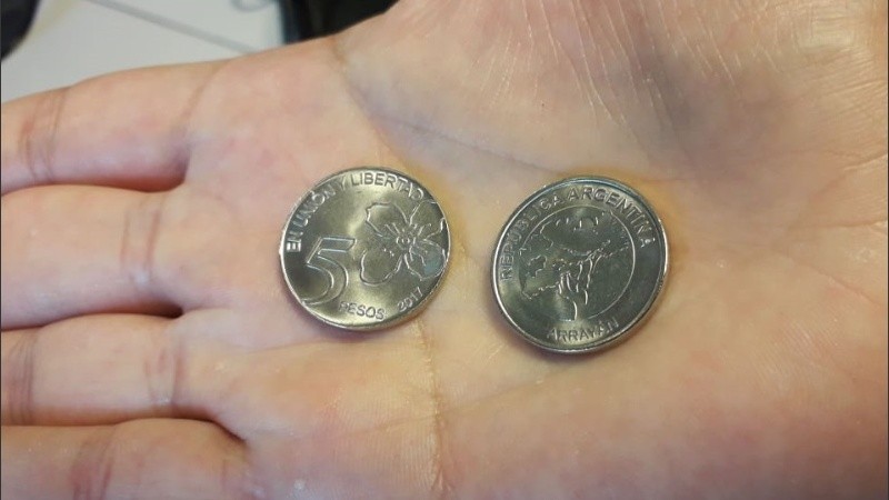 Cara y ceca de la moneda de cinco pesos.