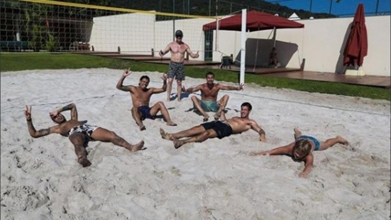 Neymar junto a sus amigos tirados en la arena. 