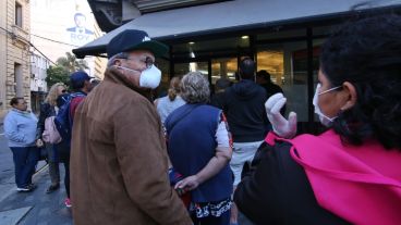 Expuestos al virus: multitud de gente espera cobrar en los bancos.