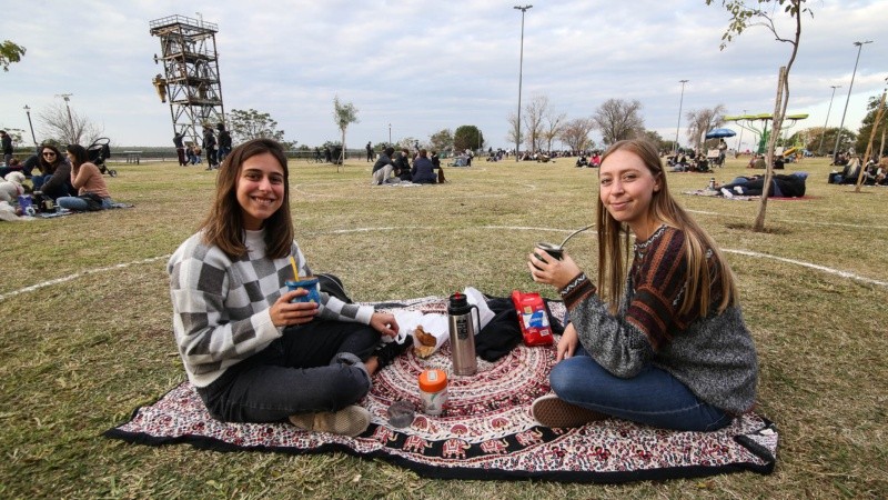 Dos amigas cada una con su mate dentro de un círculo.