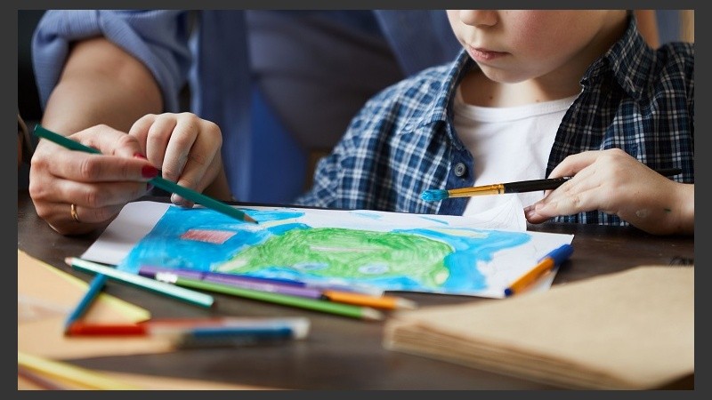 Closeup of Boy Drawing Pictures with Mom
