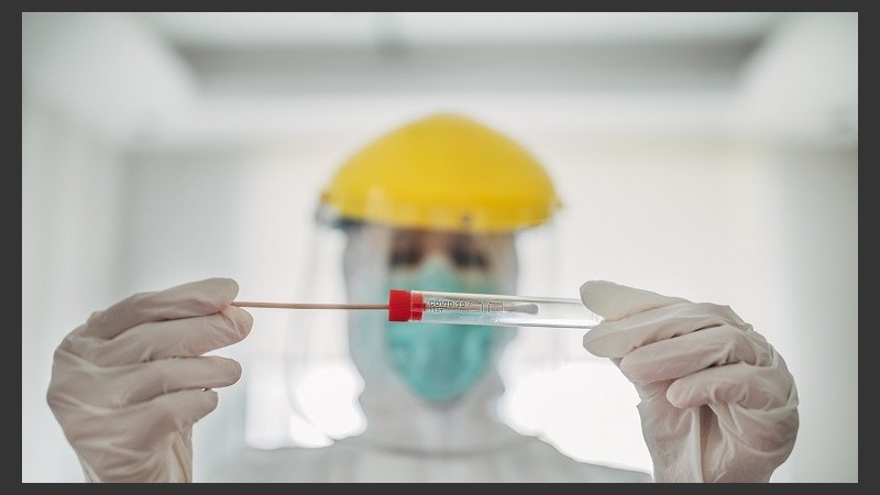 Doctor showing covid-19 tube test and sampling swab