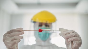 Doctor showing covid-19 tube test and sampling swab