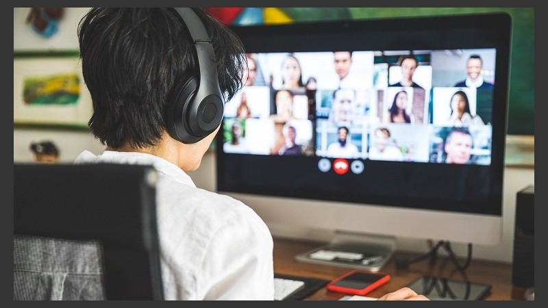 Woman working at home having a video conference with colleagues