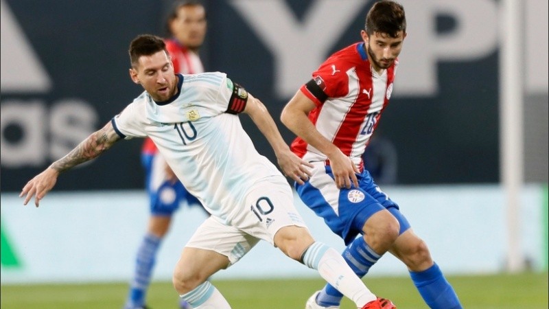 Messi disputa la pelota con un adversario en la Bombonera.
