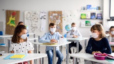 Children with face mask back at school after covid-19 quarantine and lockdown.