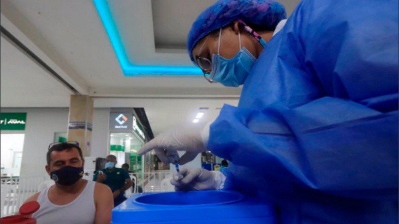 Una enfermera prepara una dosis de una vacuna durante una jornada masiva en centros comerciales en Colombia.
