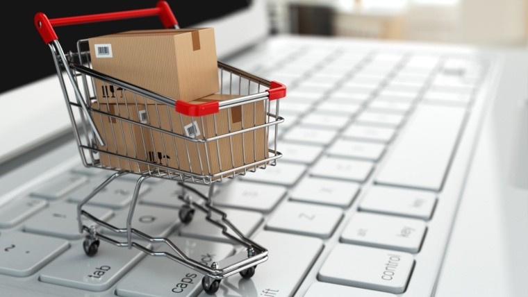 E-commerce. Shopping cart with cardboard boxes on laptop. 3d; Shutterstock ID 173225225; Purchase Order: Digital; Job: ; Client/Licensee: ; Other: