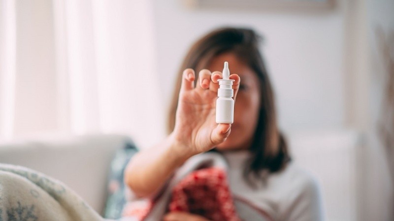 Sick Woman Holding Nasal Spray