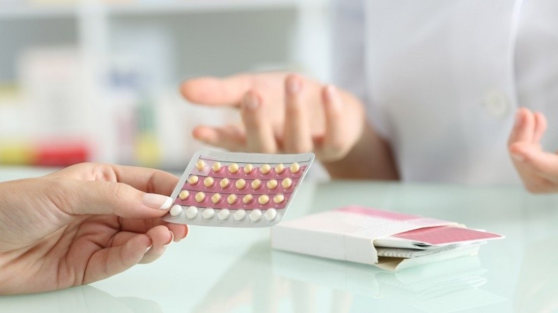 Girl buying contraceptive pills in a pharmacy