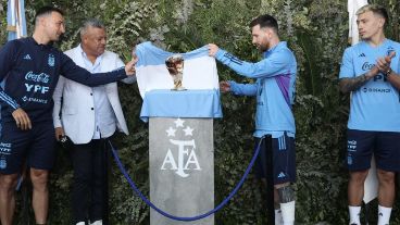 Lisandro Martínez espía como Leo Messi y Scaloni descubren la placa en Ezeiza.