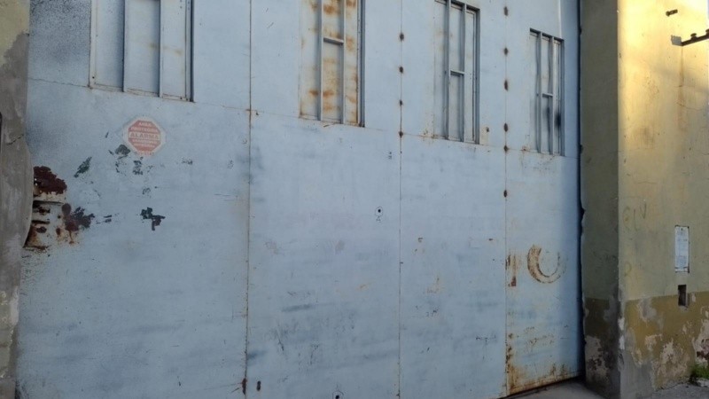 El portón del galpón baleado.