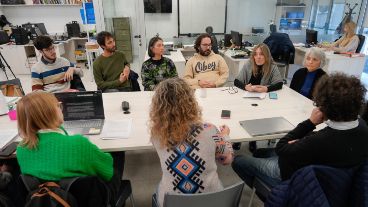 La larga mesa del Iech con becarios e investigadores a su alrededor en la entrevista con Rosario3.