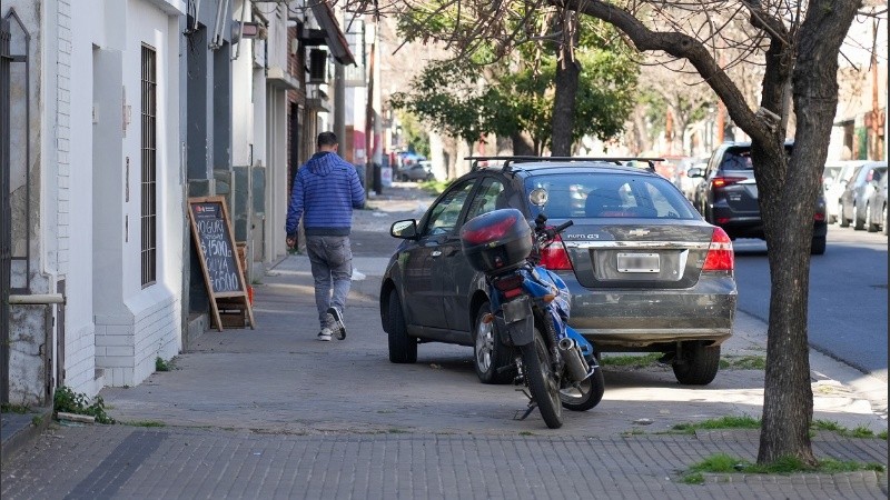Un auto y una moto obstaculizando el paso en una vereda del barrio Abasto hace unos días.