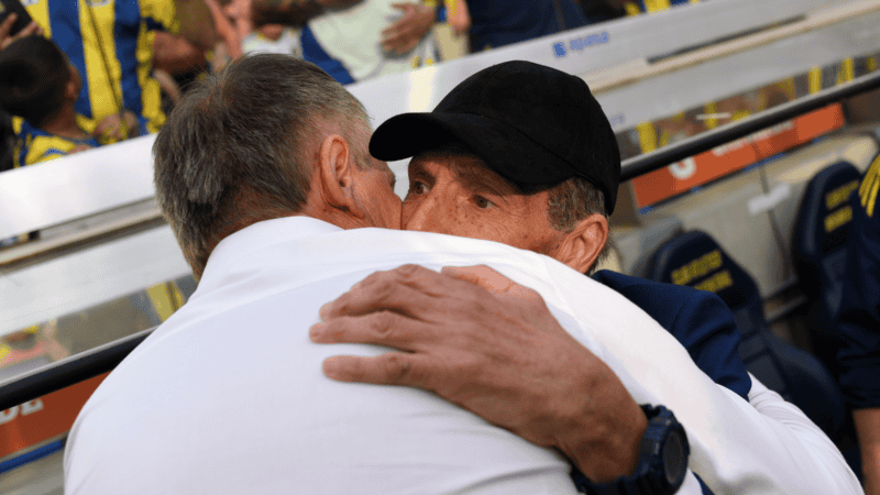 El abrazo de Holan con Russo en los bancos de suplentes del Gigante.