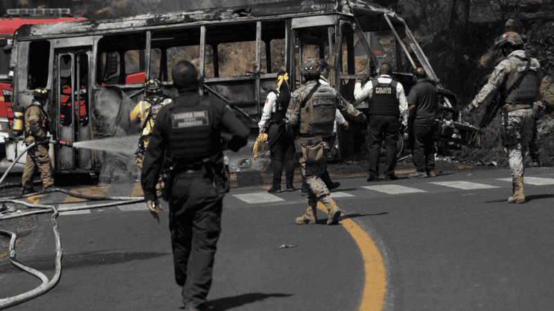 Bomberos e integrantes de la policía de Morelia trabajan en la zona donde fue incendiado un vehículo por presuntos integrantes del crimen organizado. (EFE)
