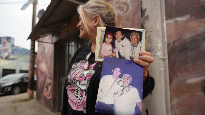 Vecinos mostrando fotos de Leo este miércoles en el barrio donde creció el 10 argentino.