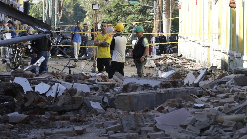 Personas observan una edificación destruida tras el terremoto de magnitud 7,4. (EFE)