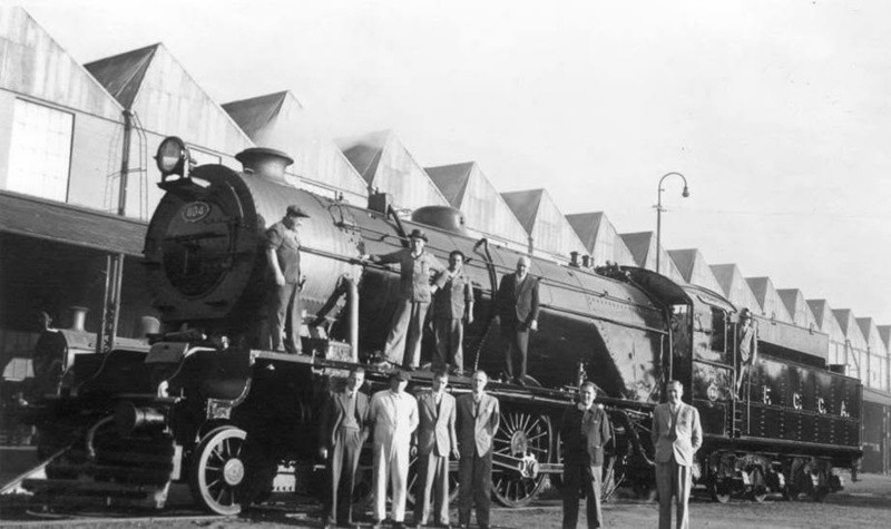 Operarios de la Gorton Works posan junto a una locomotora a vapor.